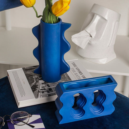 Klein blå geometrisk keramisk vase boligindretning stue spisestue bord blomsterarrangement hotel kunst dekoration vase ornament